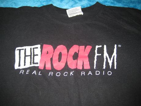 I'm with the band T shirt given out by The Rock FM. At the Rocky Cola bar - front